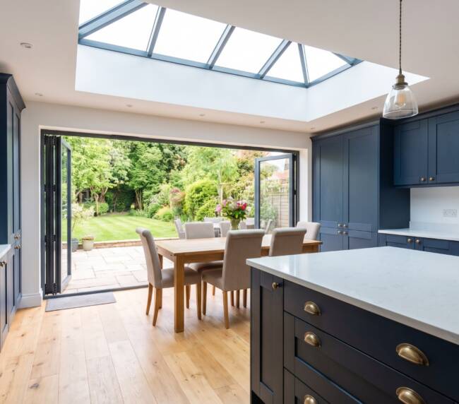 Navy blue kitchen extension with bi-fold doors and roof lantern